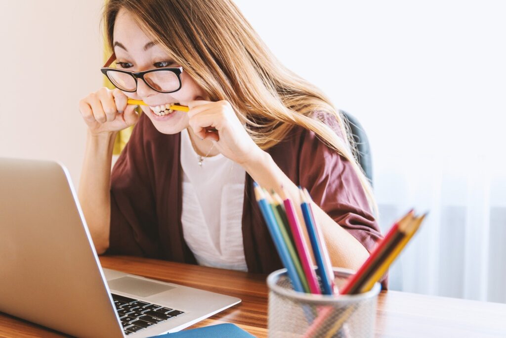 A woman studying or taking a quiz on a laptop