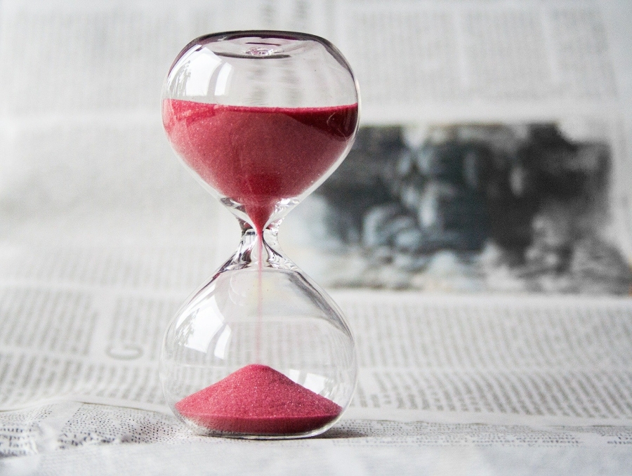 An hourglass with pink sand