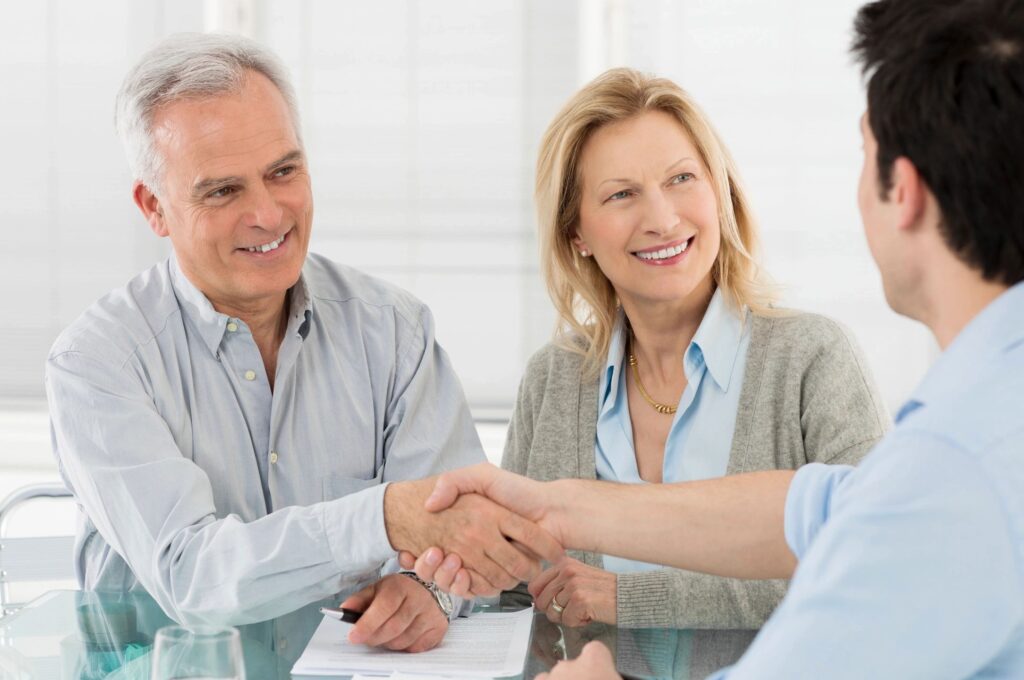 People shaking hands with a financial planner