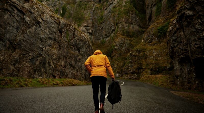 Someone carrying a bag down the road