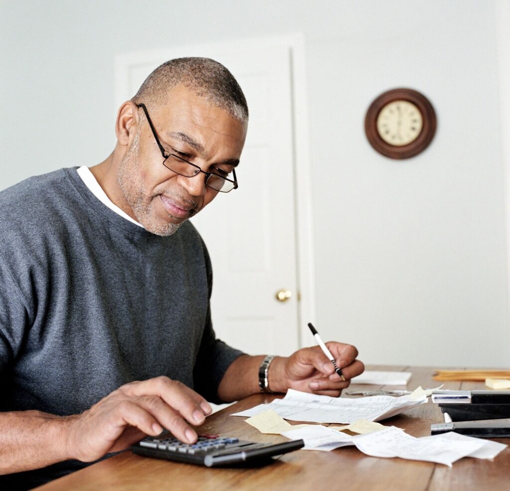 senior man paying bills