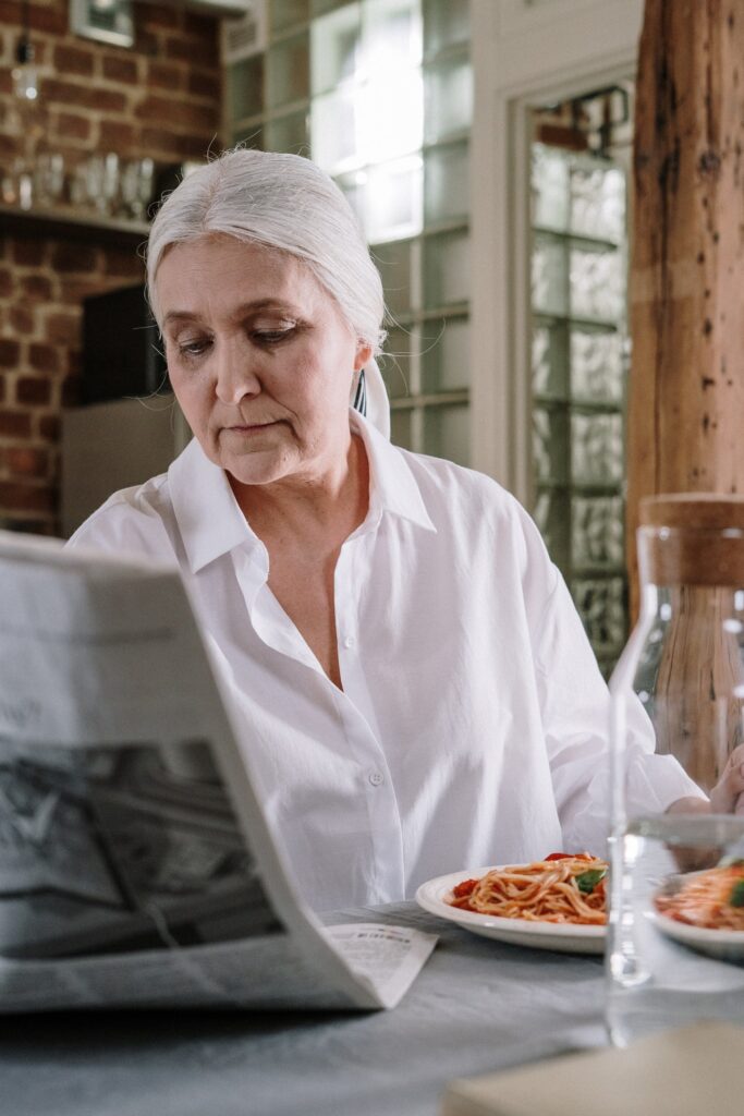 senior woman reading newspaper