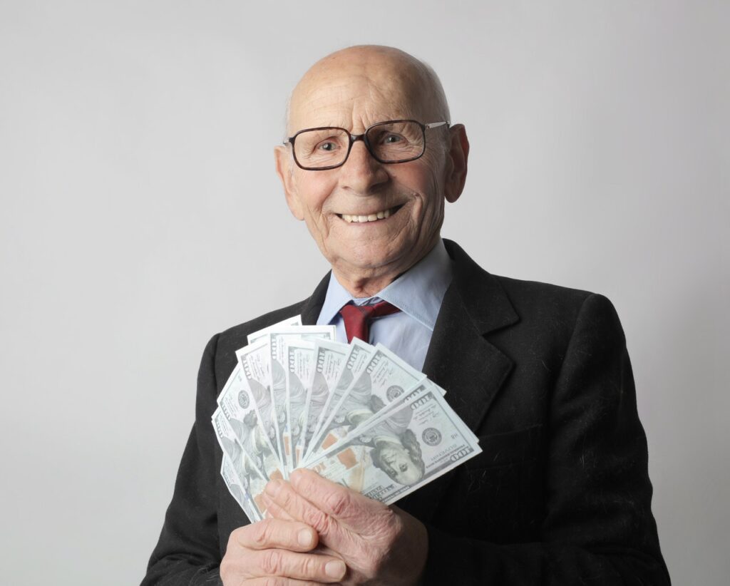 senior man holding cash