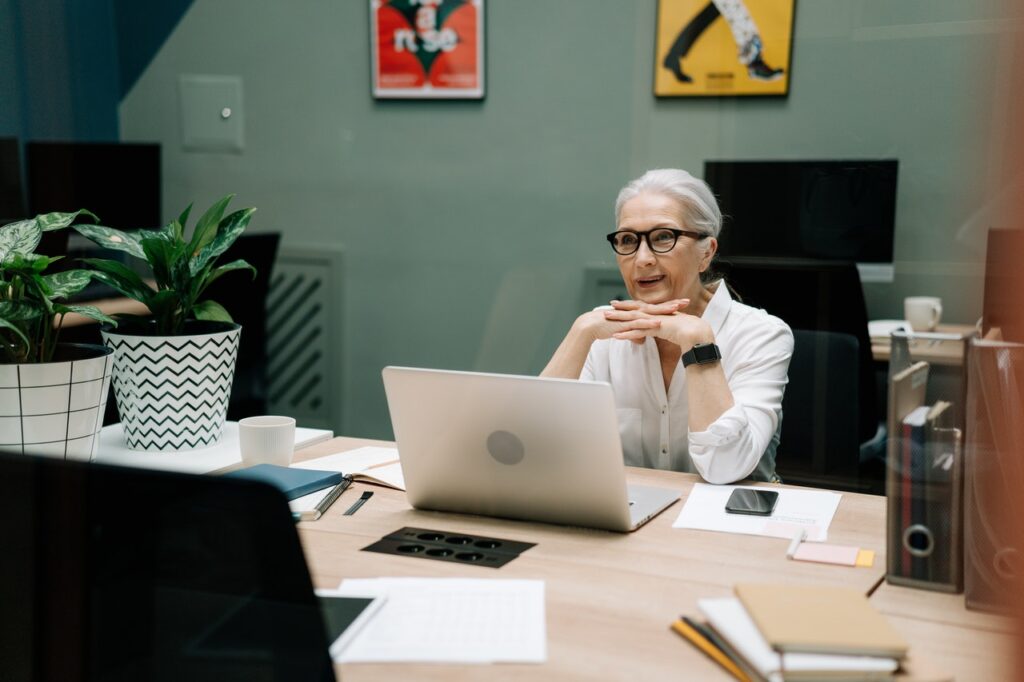 older woman at desk