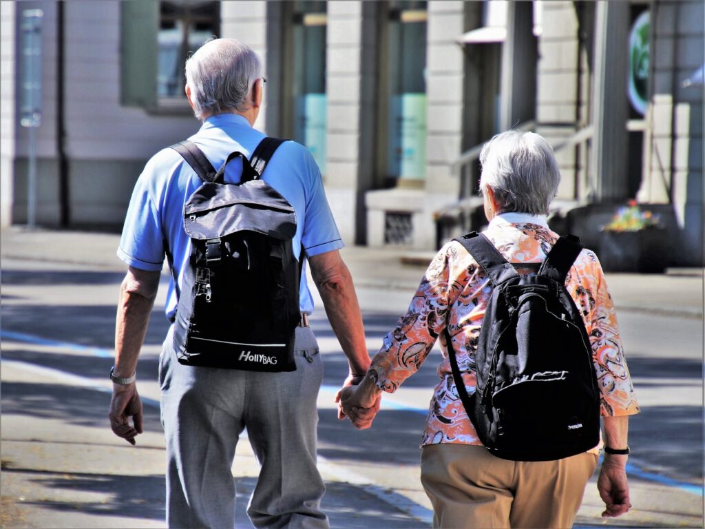 older couple wearing backpacks