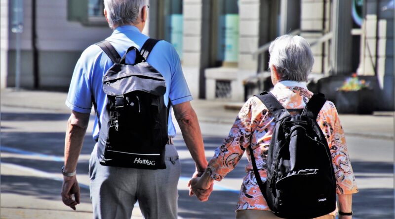 older couple wearing backpacks