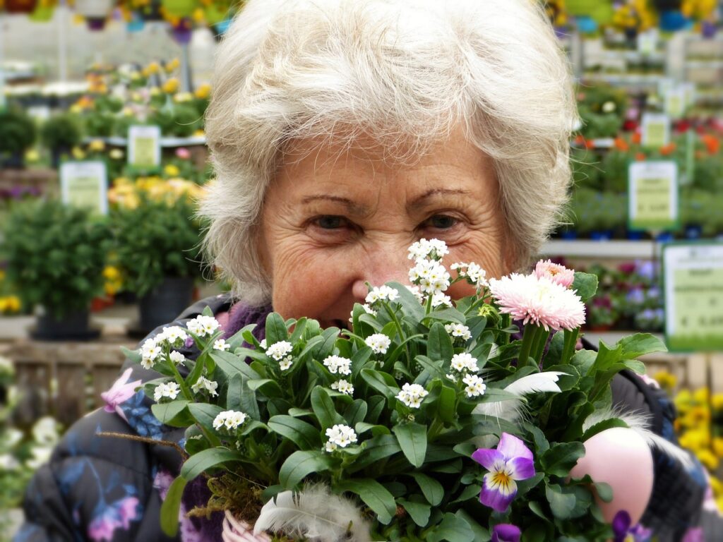 older woman holding plant