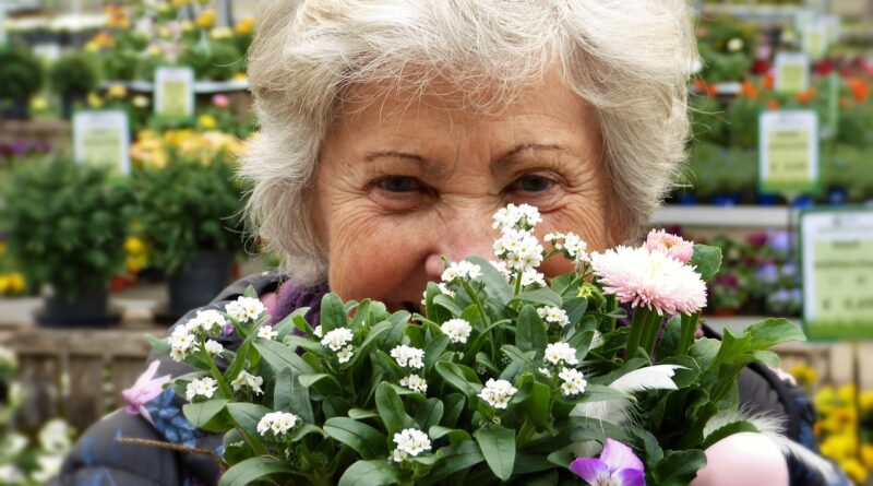 older woman holding plant
