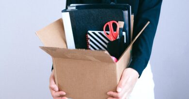 woman holding box with her desk stuff