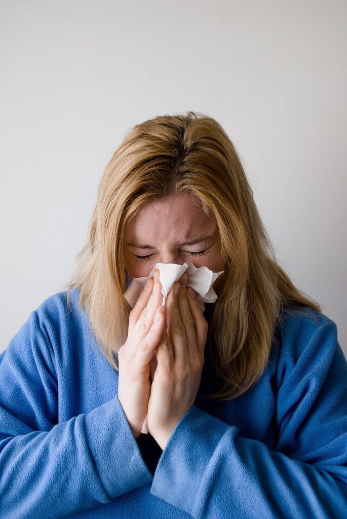 woman blowing nose