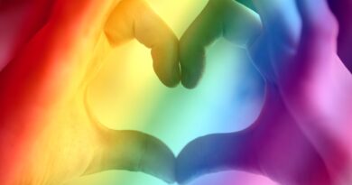 hands making heart with rainbow