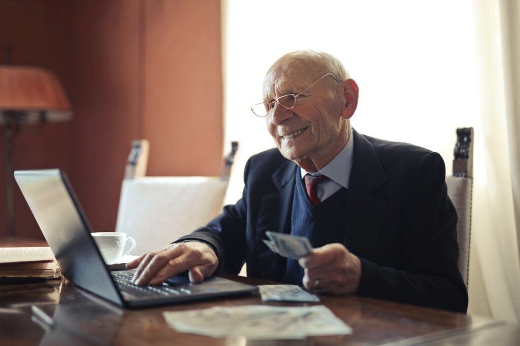 senior man holding cash