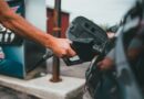 person putting gas in car