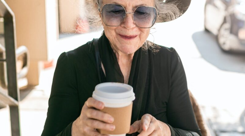 senior woman holding coffee