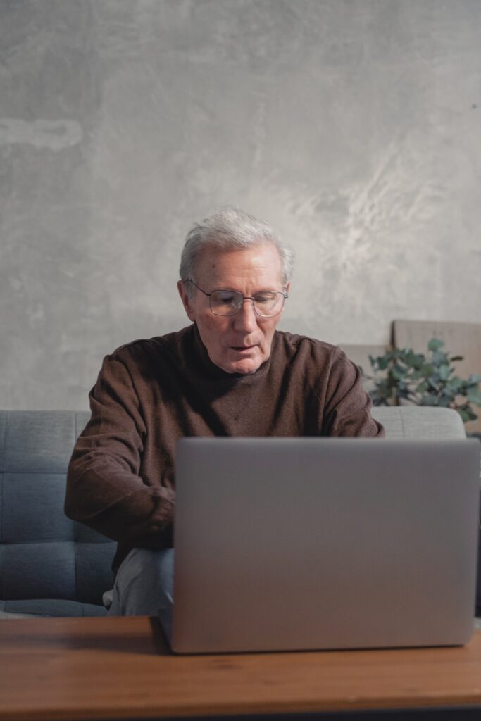 senior man watching laptop