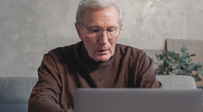 senior man watching laptop