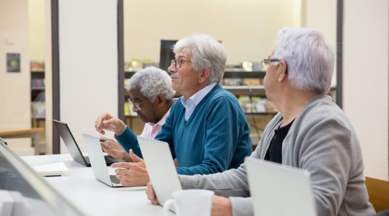 senior citizens with laptops