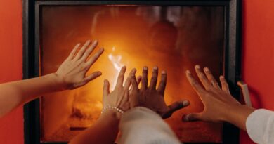 hands warming by fireplace
