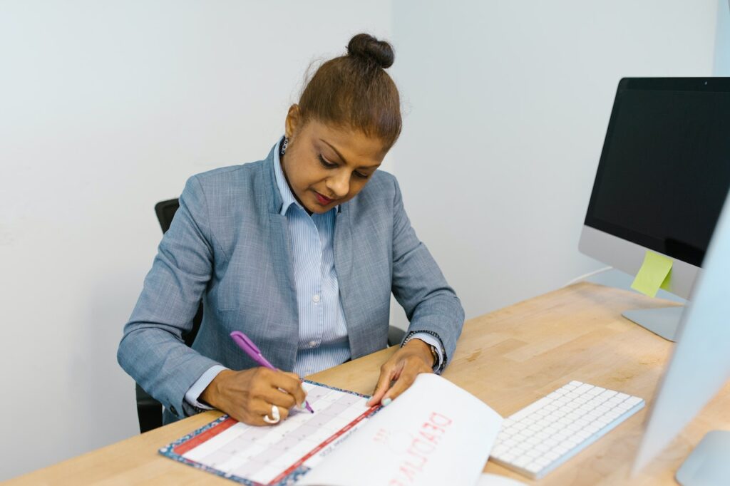 woman writing on calendar