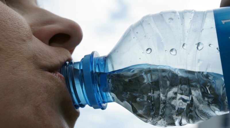 woman drinking bottled water