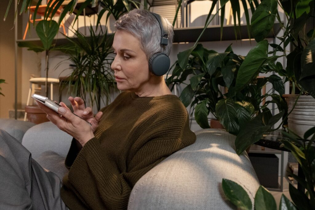 senior woman listening with headphones