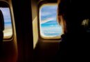 person looking out plane window