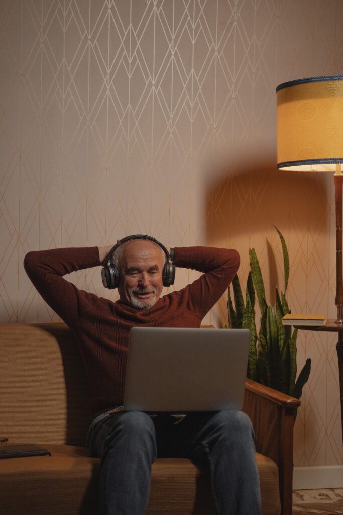 senior man watching video on laptop