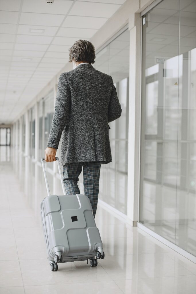 man walking with carry-on suitcase