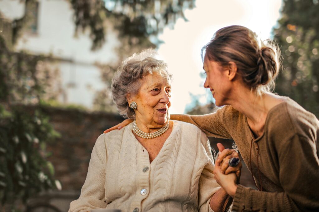 woman comforting elderly woman