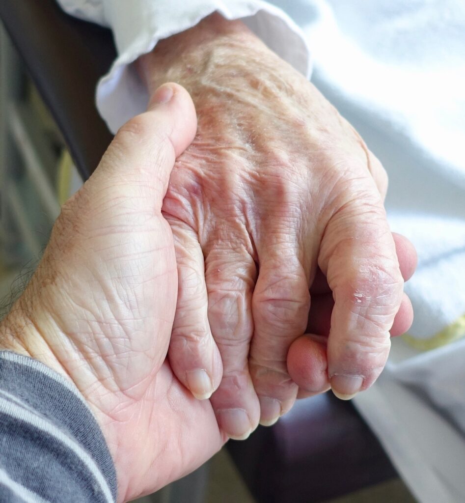 elderly holding hands