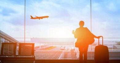 man at airport watching plane