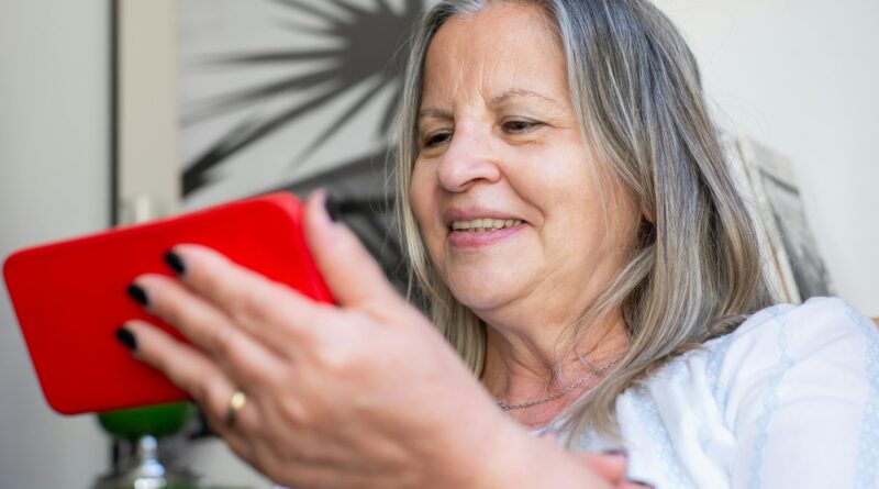 senior woman holding cell phone
